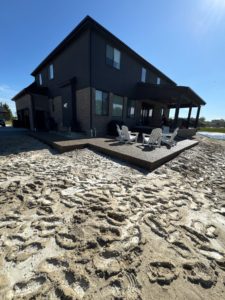 House with outdoor patio by the lake