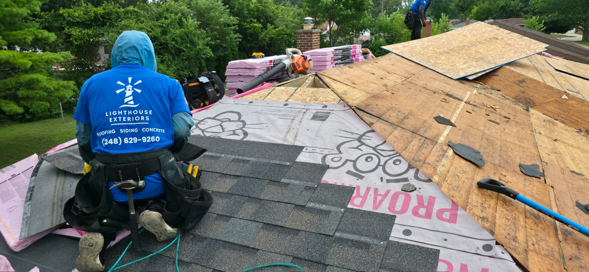 The Lighthouse Exteriors team working on top of a roof