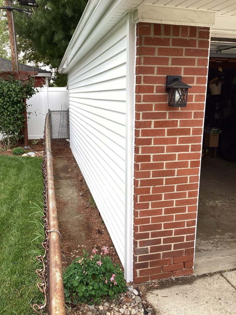 After image with white siding on a house