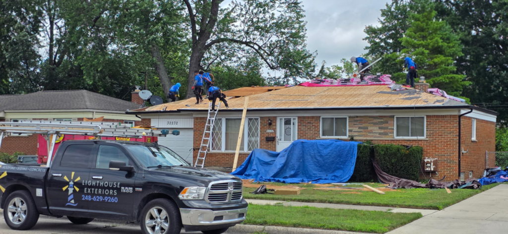 Lighthouse Exteriors working on a roofing project
